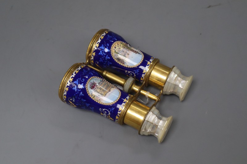 A pair of gilt brass and enamel opera glasses, with mother of pearl overlay and painted Italian scenes, length 13.5cm (a.f.)